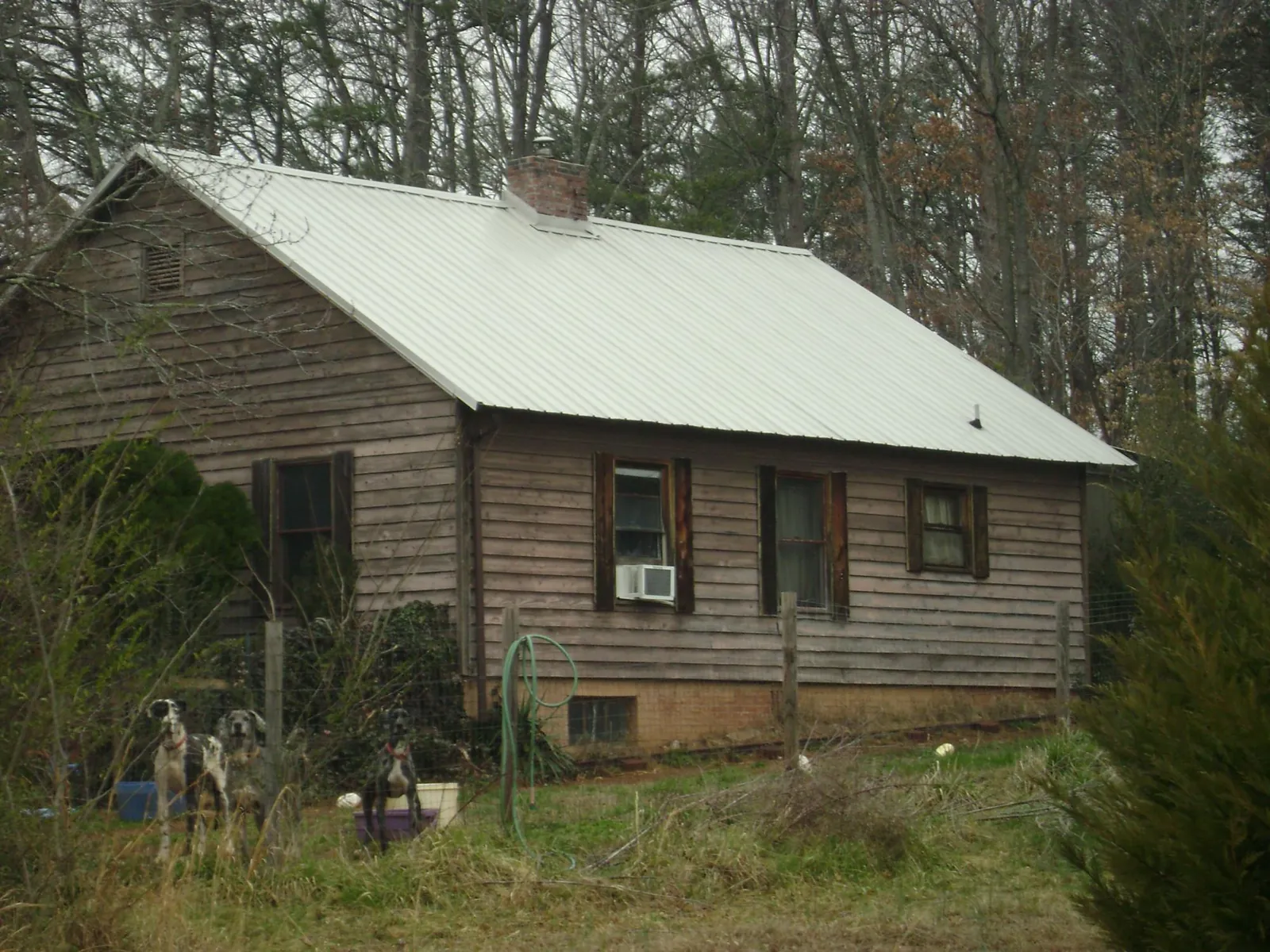 White metal roof on an old wood sided farmhouse, from a Metal Roof Installation job in Damascus
